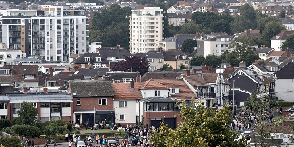 Bournemouth housing scene with diverse architecture and people.